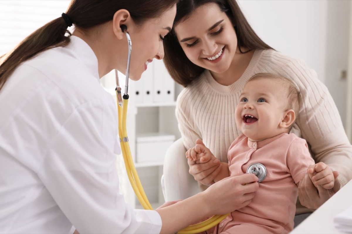Pediatrician examining a baby during a consultation with the mother